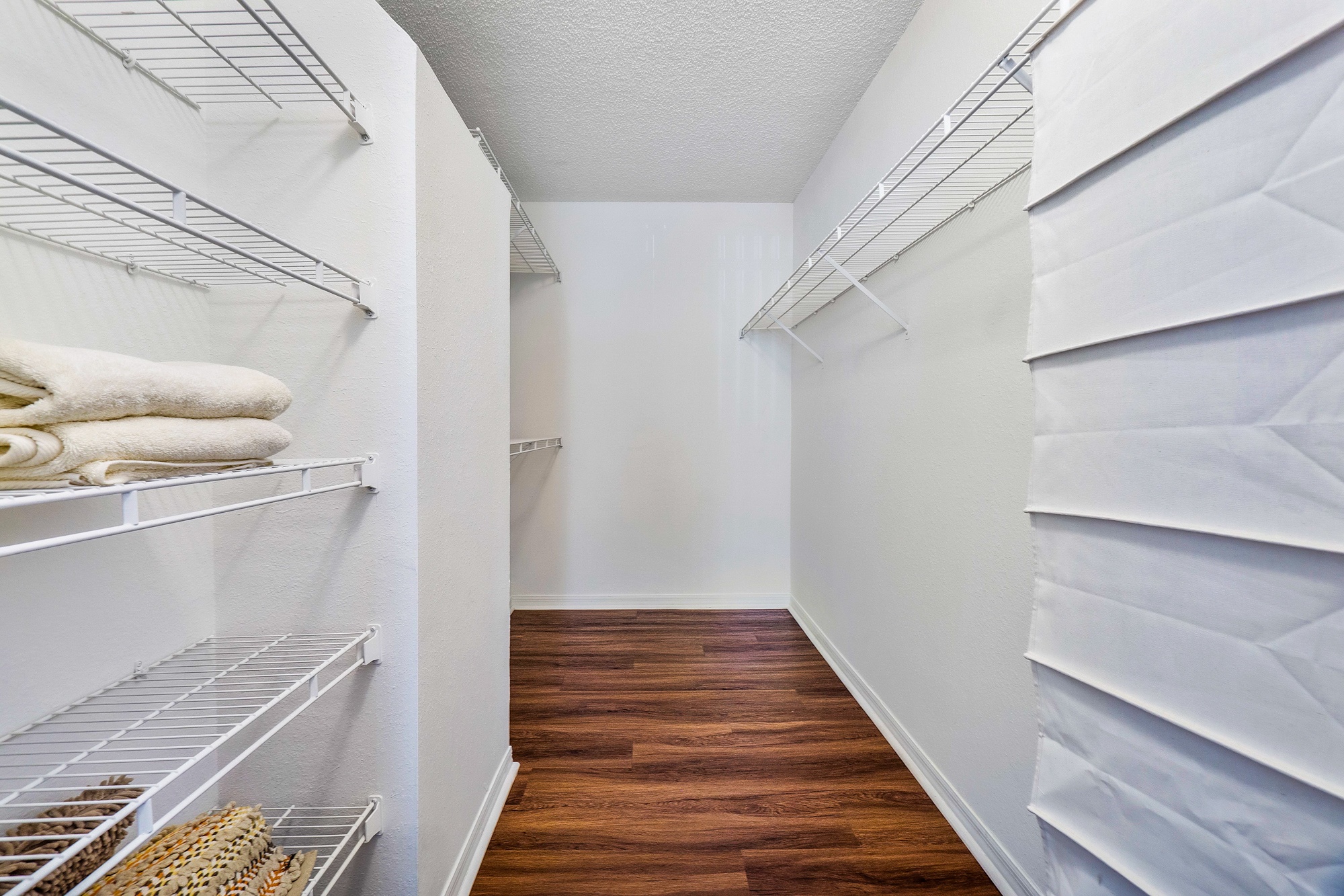 A white refrigerator with a white towel on the top shelf.